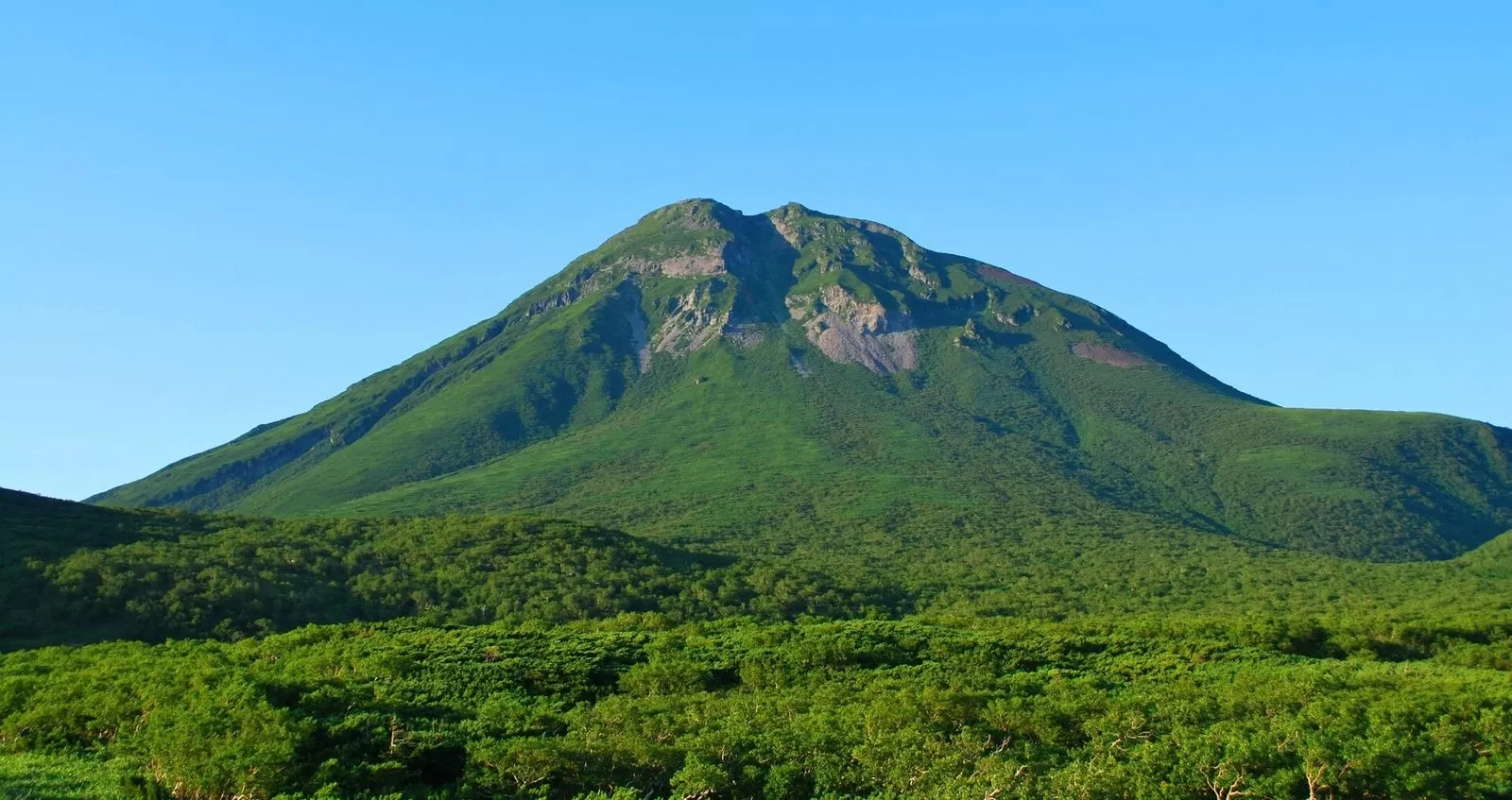 Mt. Rausu seen from Shiretoko Pass, a grand mountain scene with green ridgelines